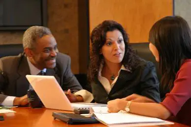 A group of people sitting around a table.