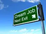 A green sign that says " dream job next exit ".